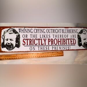 Humorous Wall Sign with Red and Black Text